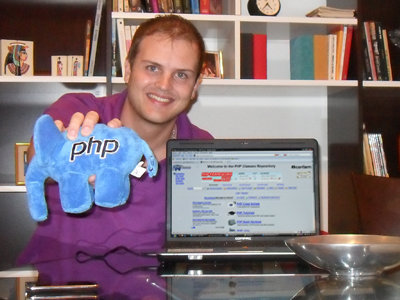 Picture of Guilherme Ribas holding the elePHPant PHP mascot toy Picture of Guilherme Ribas holding the elePHPant PHP mascot toy